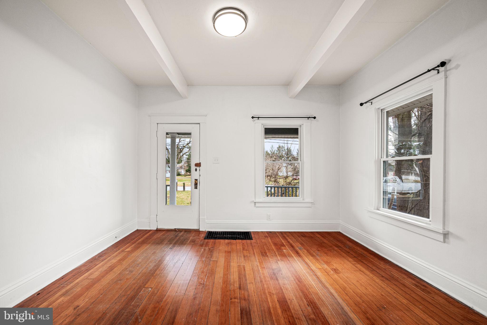 1026 Hares Hill Road Phoenixville, PA 19460 - Photo 7 of 27 an empty room with wooden floor and windows