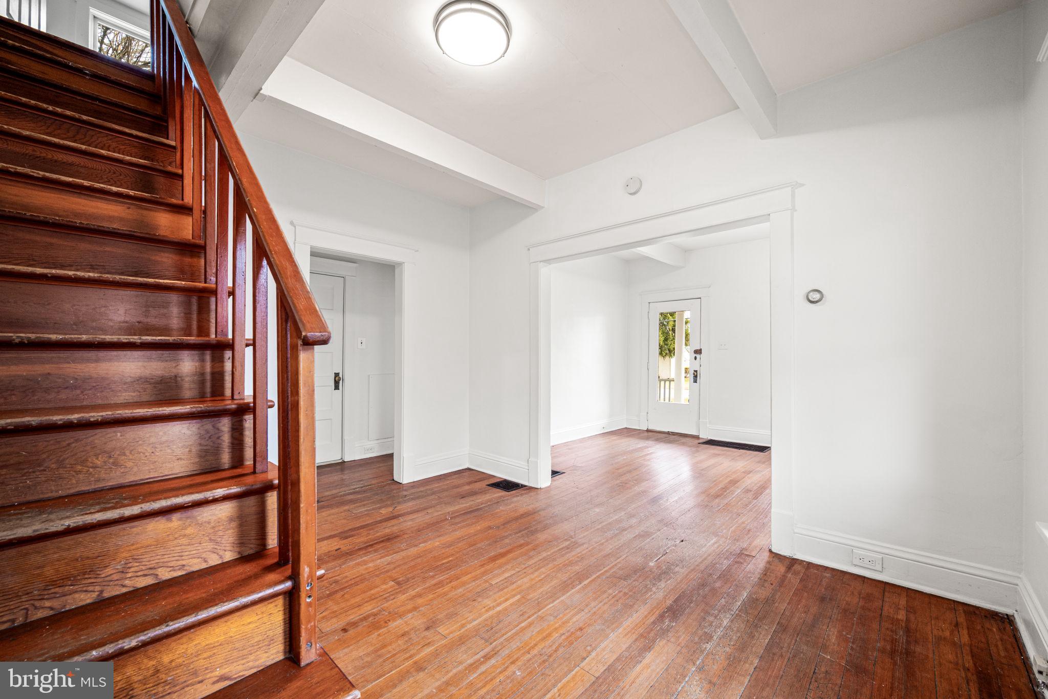 1026 Hares Hill Road Phoenixville, PA 19460 - Photo 9 of 27 a view of an empty room with wooden floor and stairs