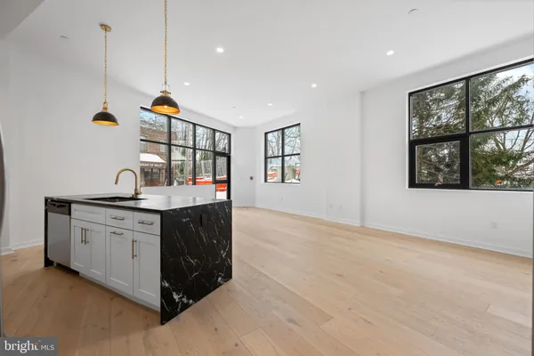 a kitchen with stainless steel appliances granite countertop a stove and a sink