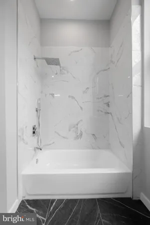 a bathroom with bathtub and shower