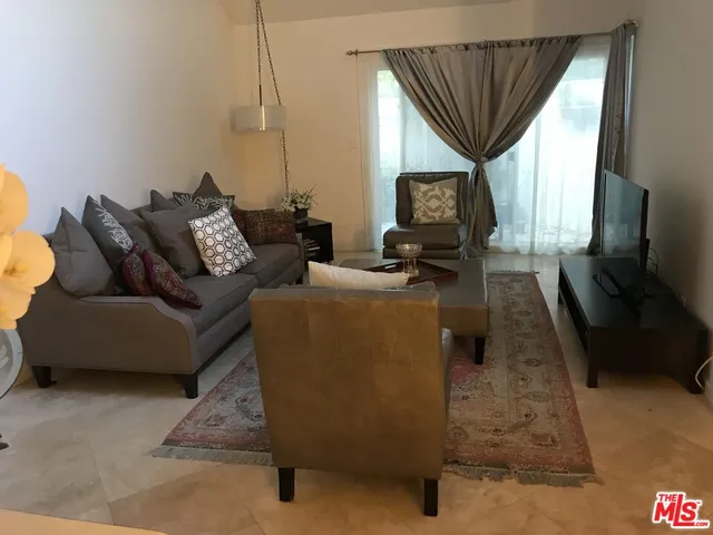 a view of a livingroom with furniture and window