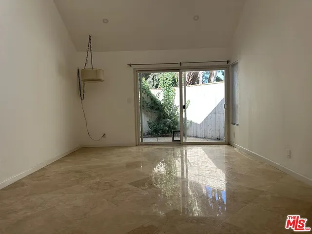 a kitchen with a refrigerator and a stove