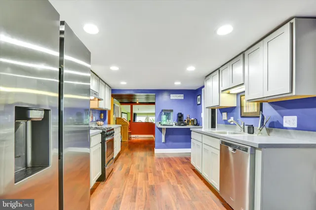 a living room with furniture and a painting on the wall