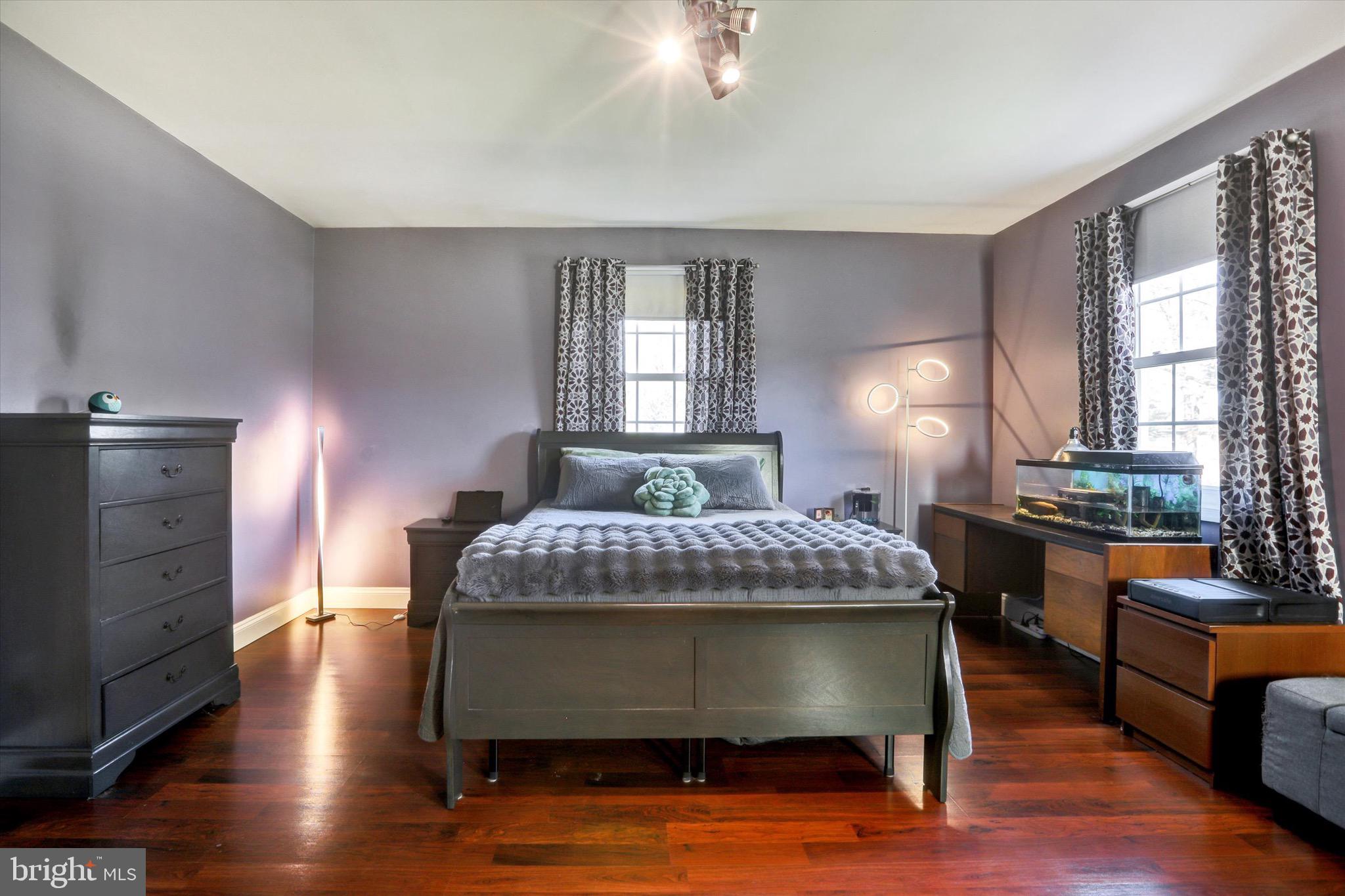 220 West Timonium Road Lutherville-Timonium, MD 21093 - Photo 31 of 64 a bedroom with a bed and wooden floor