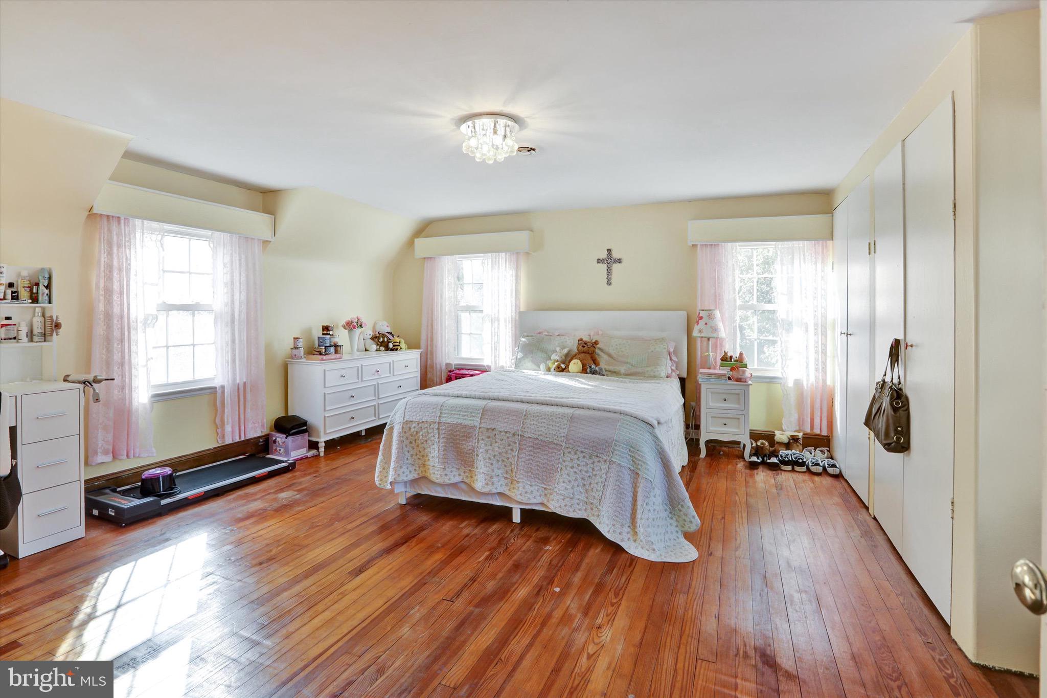 220 West Timonium Road Lutherville-Timonium, MD 21093 - Photo 36 of 64 a bedroom with a bed and wooden floor