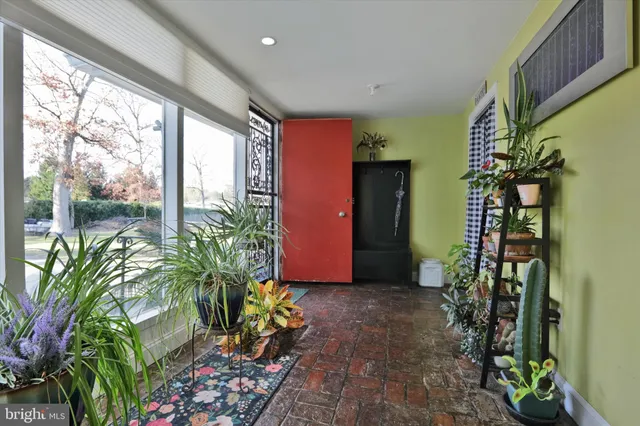 a view of a dining room with furniture and a potted plant
