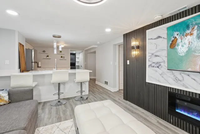 a large white kitchen with a sink and cabinets