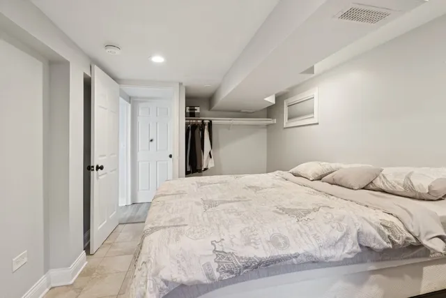 a large white bed in a white room