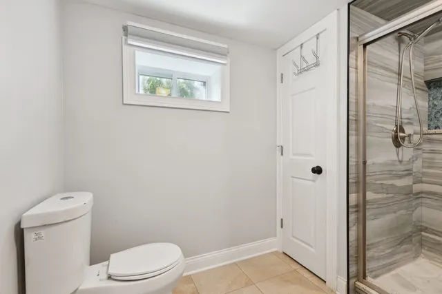 a bathroom with a toilet and a shower