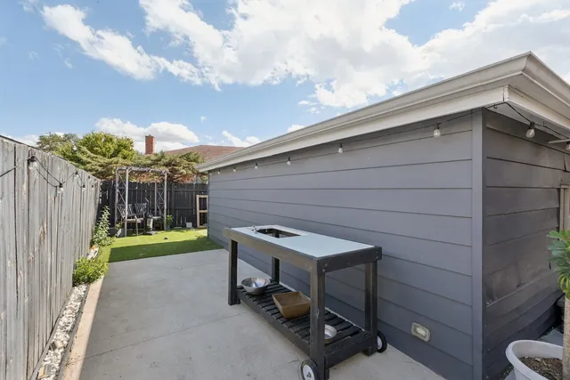 a car parked in front of a house with a yard