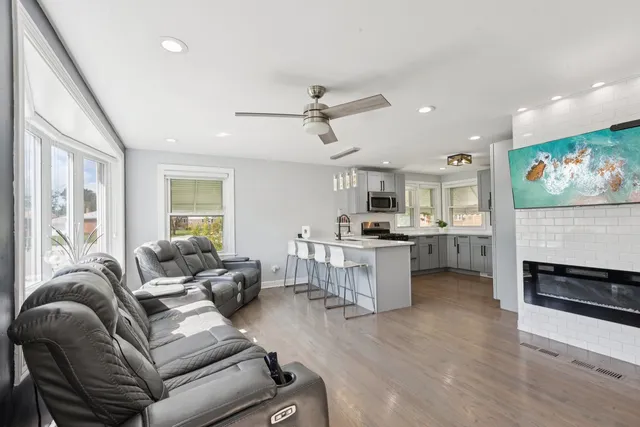 a living room with furniture and kitchen view