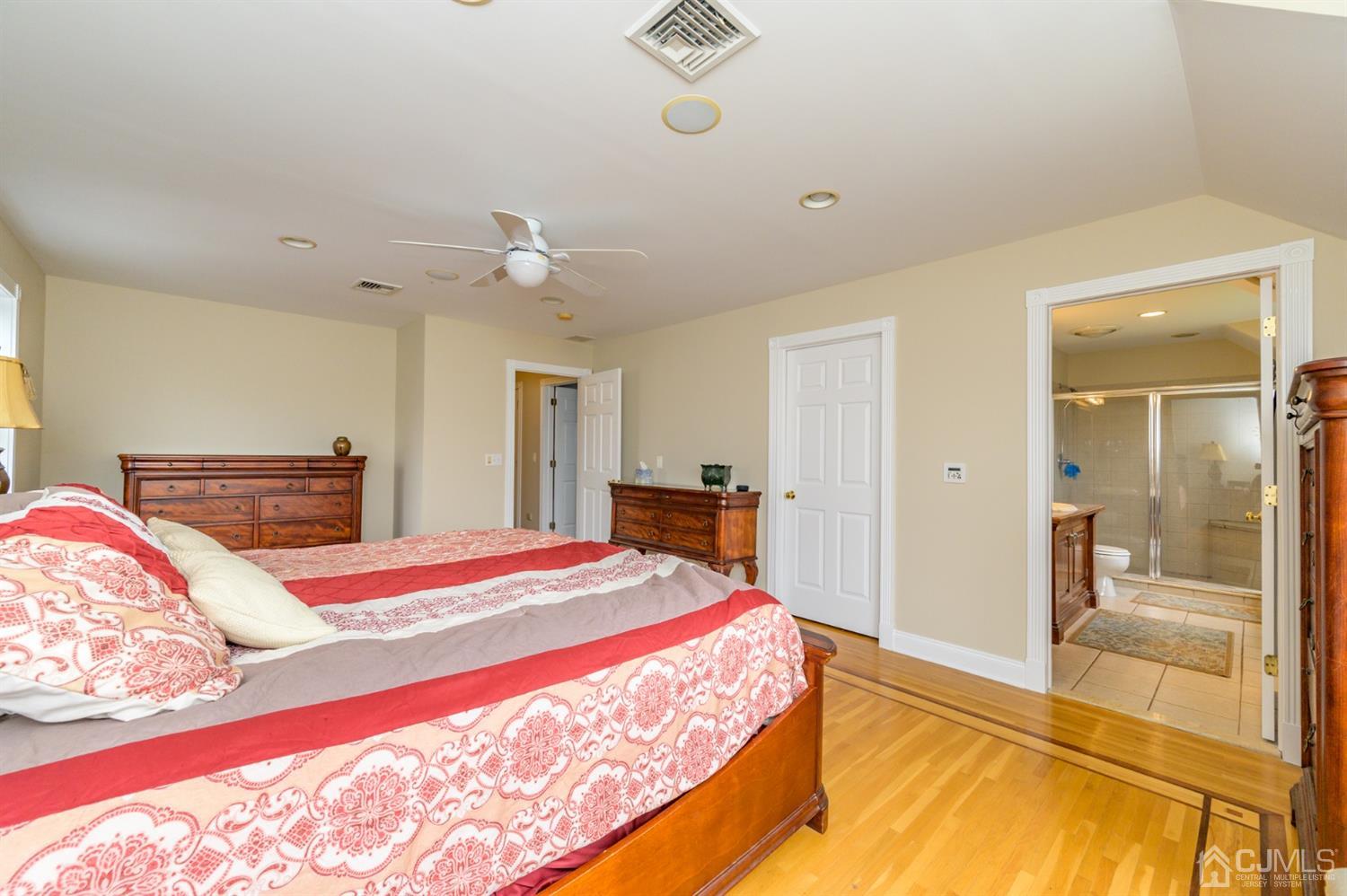 36 Cedar Grove Road Branchburg, NJ 08876 - Photo 27 of 51 a bedroom with a large bed and a chandelier
