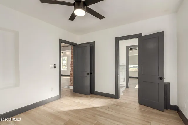 a white house that has a tree in front of it