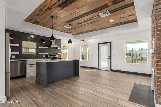 a kitchen with stainless steel appliances granite countertop a stove and a refrigerator