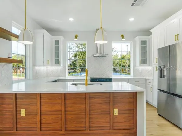 a kitchen with a sink stove and cabinets