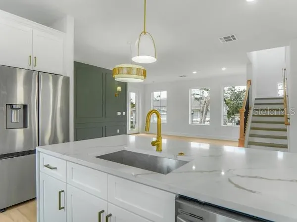 a kitchen with a stove and a white cabinets