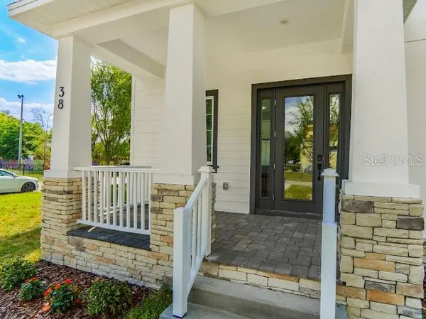 a view of a house with a small yard and wooden floor and fence