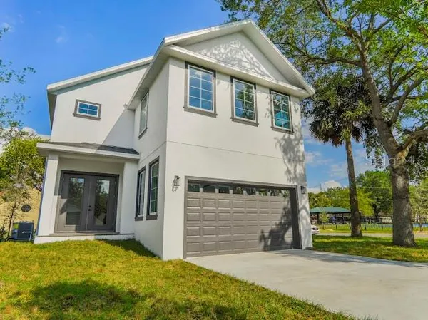 an aerial view of residential houses with outdoor space and swimming pool