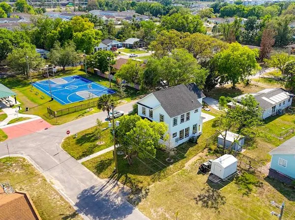an aerial view of a house with a yard and lake view