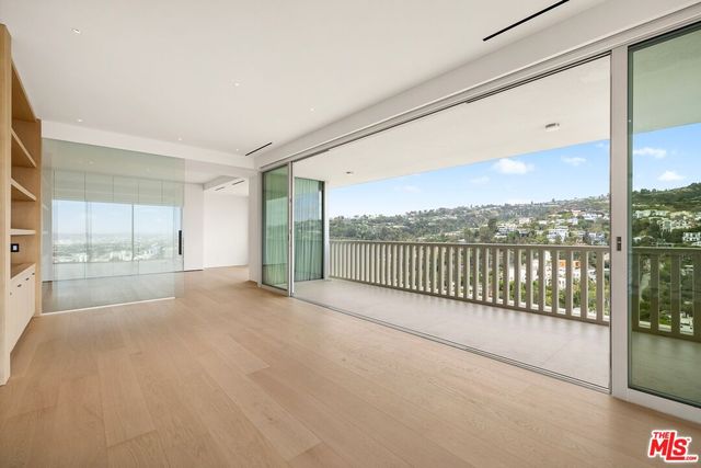 a view of a room with wooden floor and city view