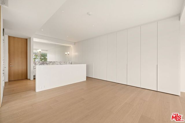 a view of an entryway with a floor to ceiling window and wooden floor