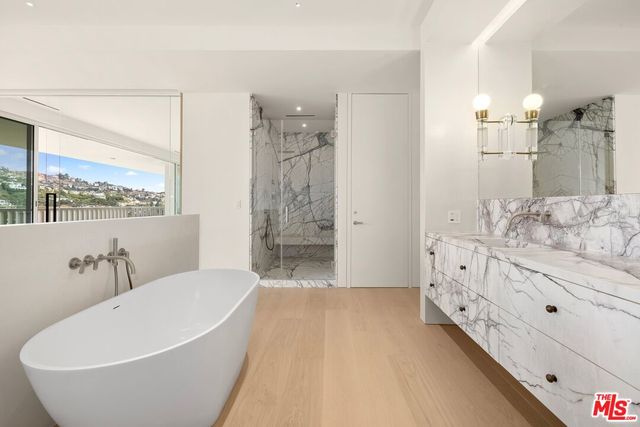 a view of a bedroom with a bed and lamp