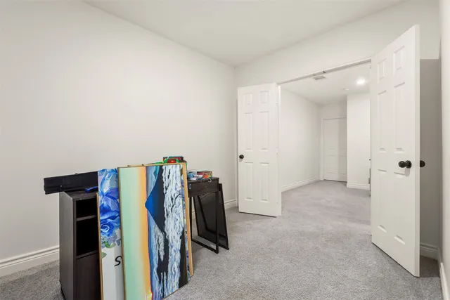 a view of walk in closet with clothes