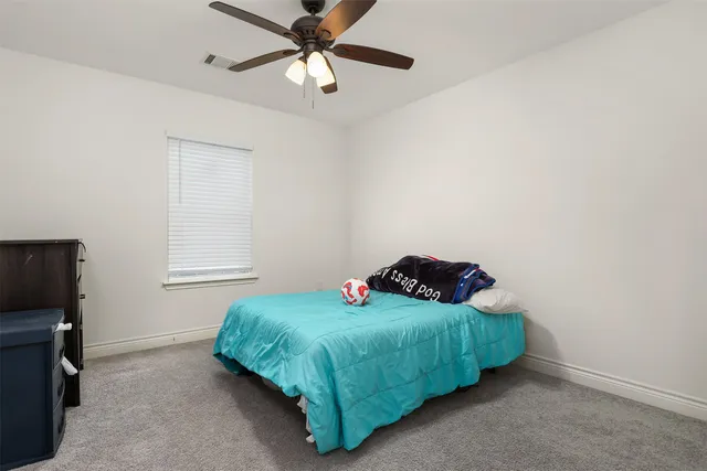 a bedroom with a bed and a tv