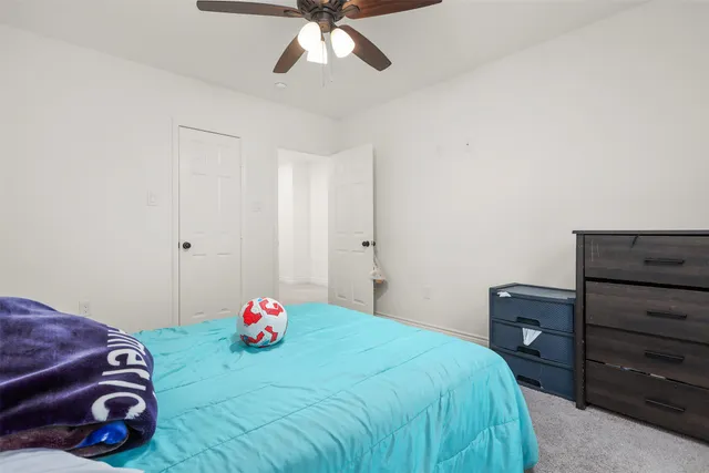 a bedroom with a bed and a closet