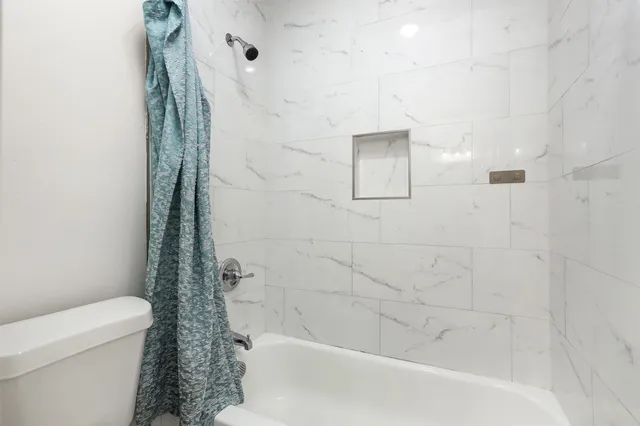 a bathroom with a shower and a toilet