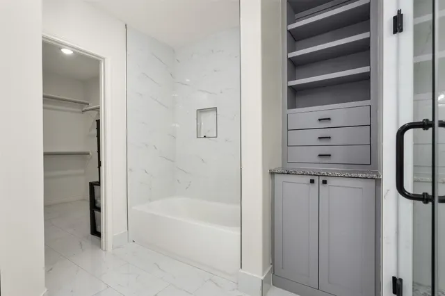 a bathroom with a bathtub and a shower