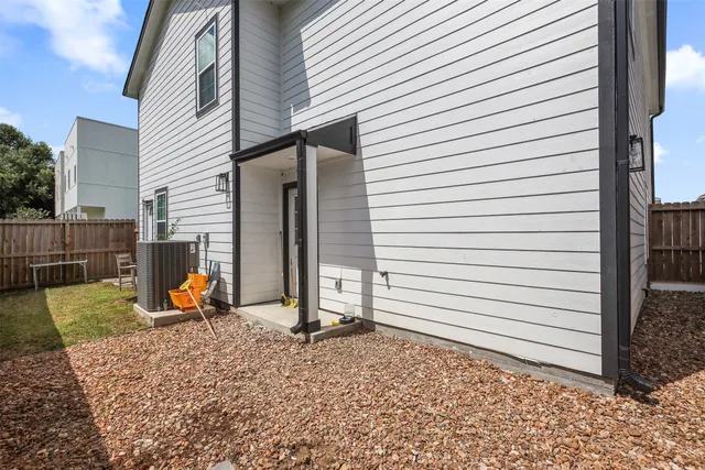 a view of a backyard with a chair and the house