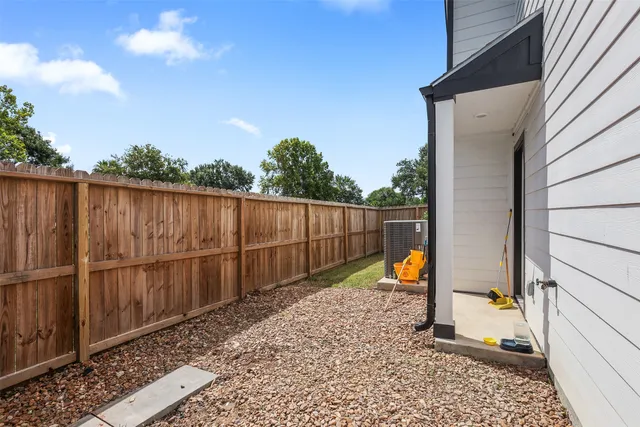 a view of a backyard with a wooden fence