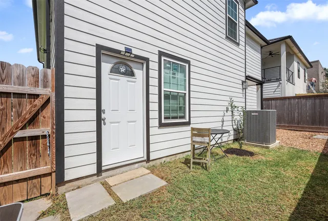 a view of a chair and table in backyard of the house