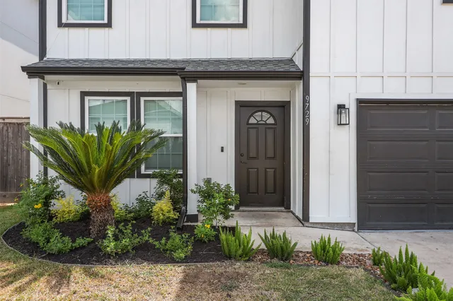 a front view of a house with potted plants