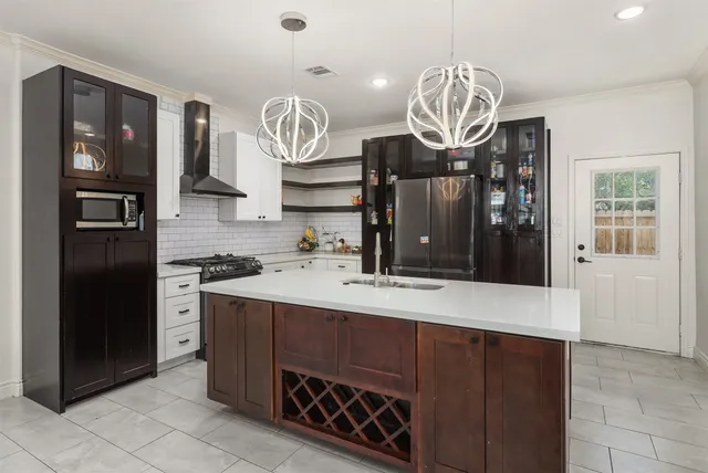 a kitchen with a refrigerator and a stove