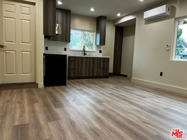 a view of kitchen with cabinets and wooden floor