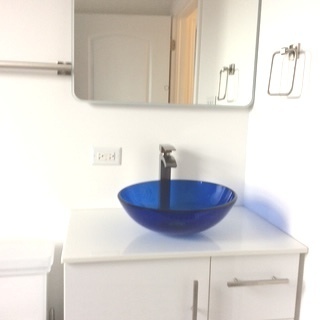 11633 South Avenue H Chicago, IL 60617 - Photo 52 of 57 a bathroom with a sink and a mirror
