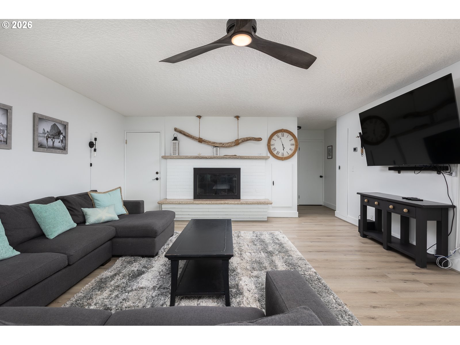 3087 South Hemlock Street Cannon Beach, OR 97110 - Photo 12 of 48 a living room with furniture and a flat screen tv