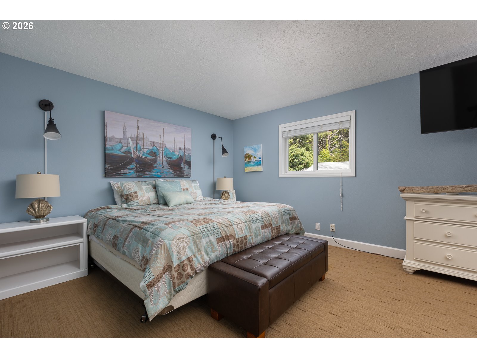 3087 South Hemlock Street Cannon Beach, OR 97110 - Photo 13 of 48 a bedroom with a bed and a flat screen tv