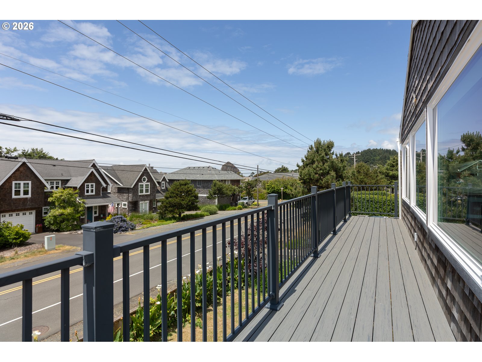 3087 South Hemlock Street Cannon Beach, OR 97110 - Photo 20 of 48 a view of a street with wooden fence