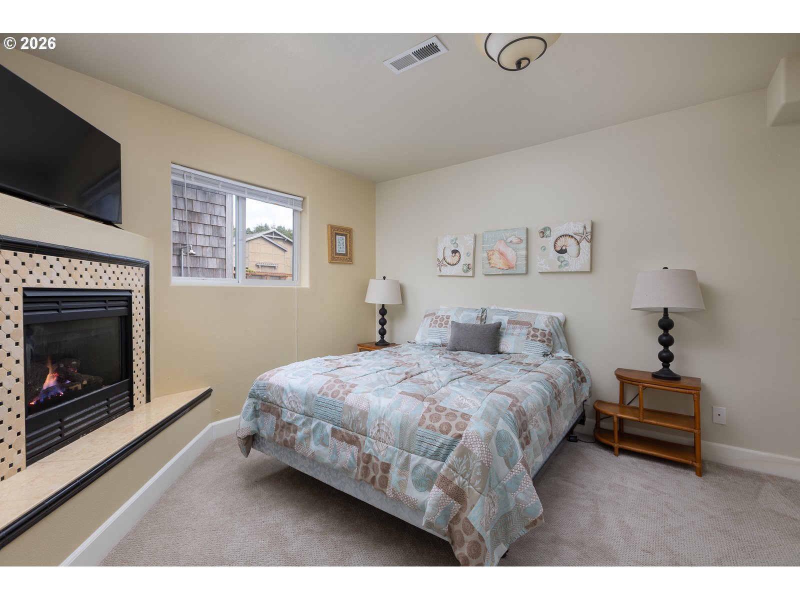 3087 South Hemlock Street Cannon Beach, OR 97110 - Photo 26 of 48 a bedroom with a bed and a fireplace