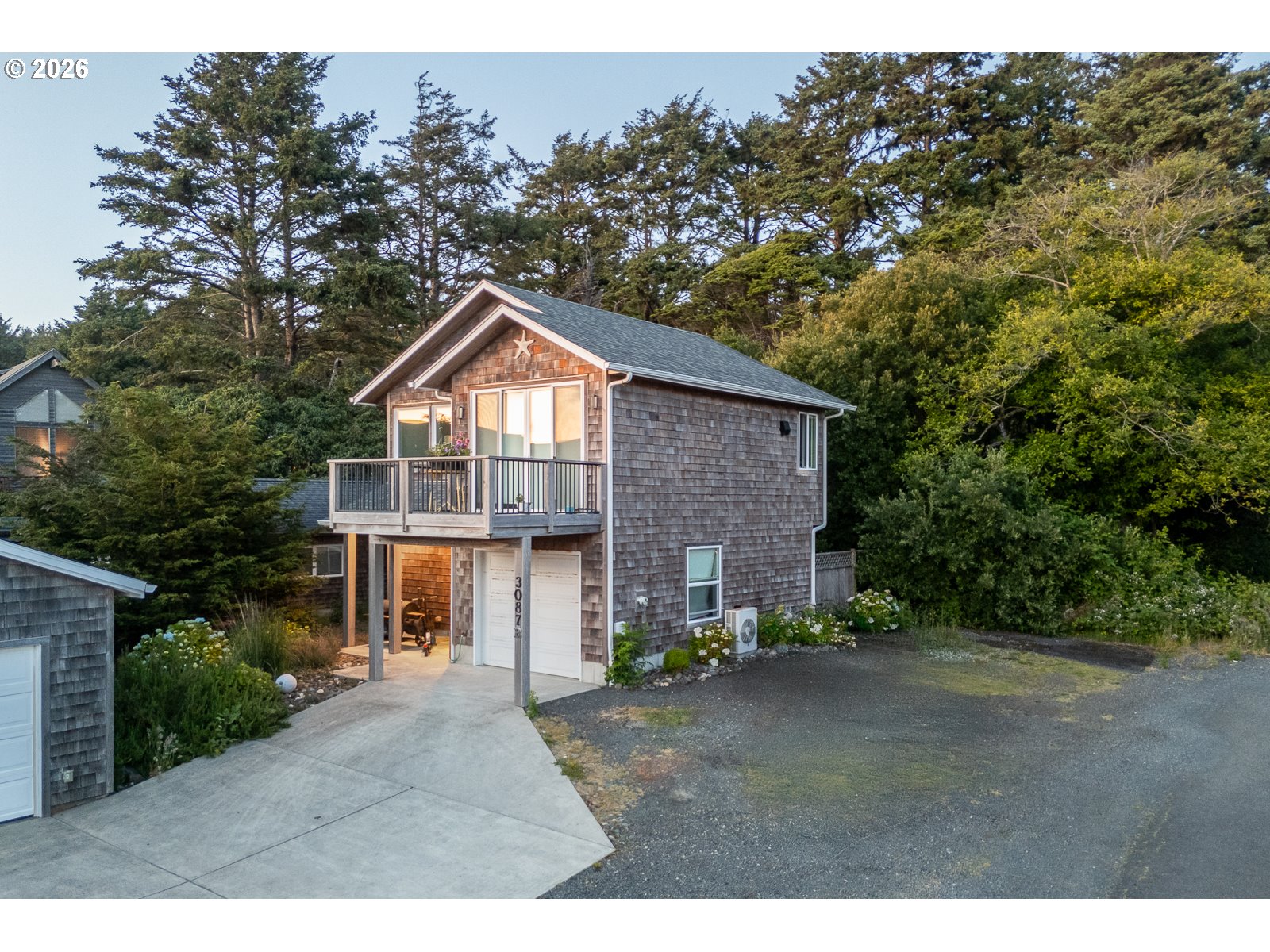 3087 South Hemlock Street Cannon Beach, OR 97110 - Photo 33 of 48 a front view of a house with a garden