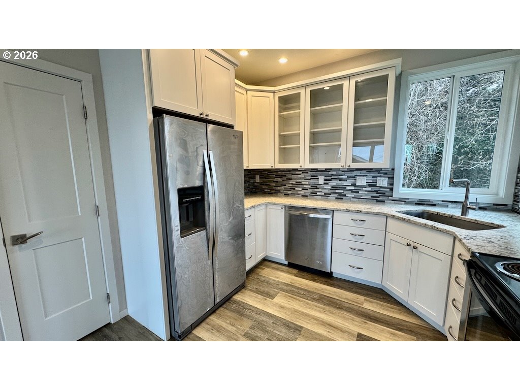 3087 South Hemlock Street Cannon Beach, OR 97110 - Photo 39 of 48 a kitchen with a sink stove and refrigerator