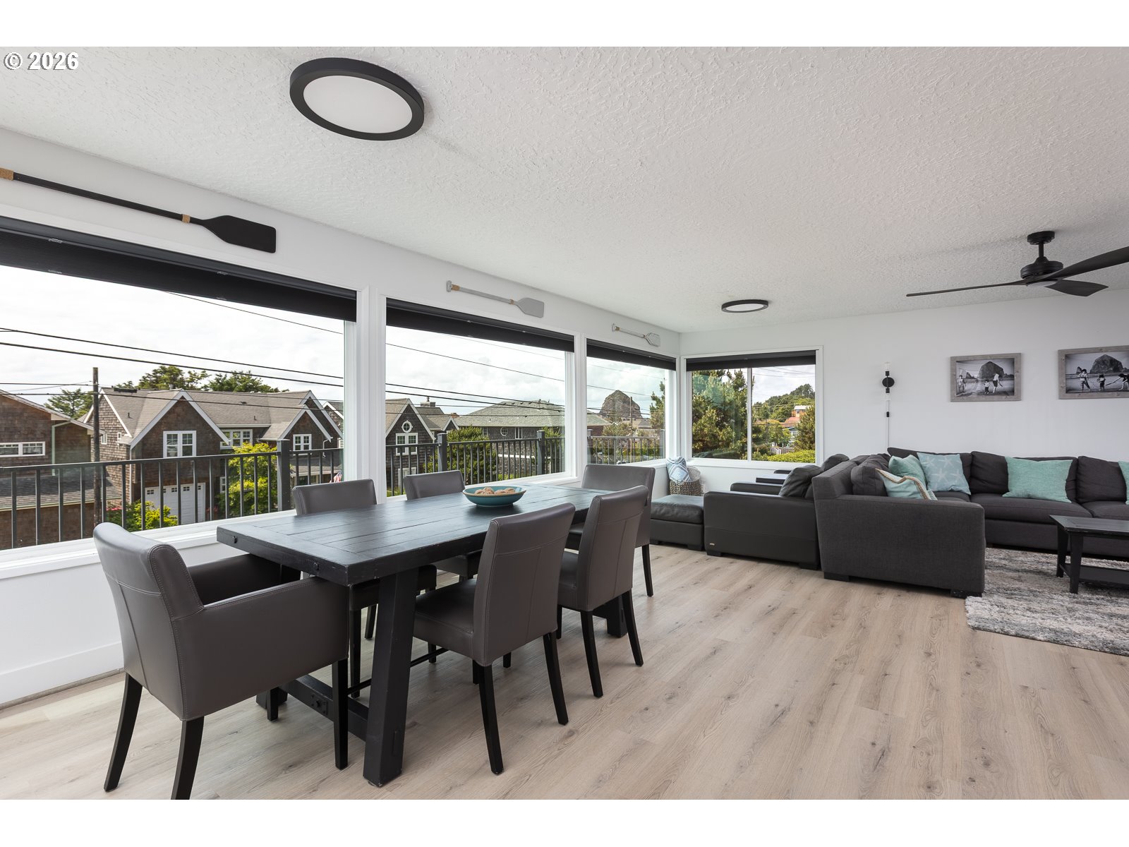 3087 South Hemlock Street Cannon Beach, OR 97110 - Photo 6 of 48 a living room with furniture a flat screen tv and a large window