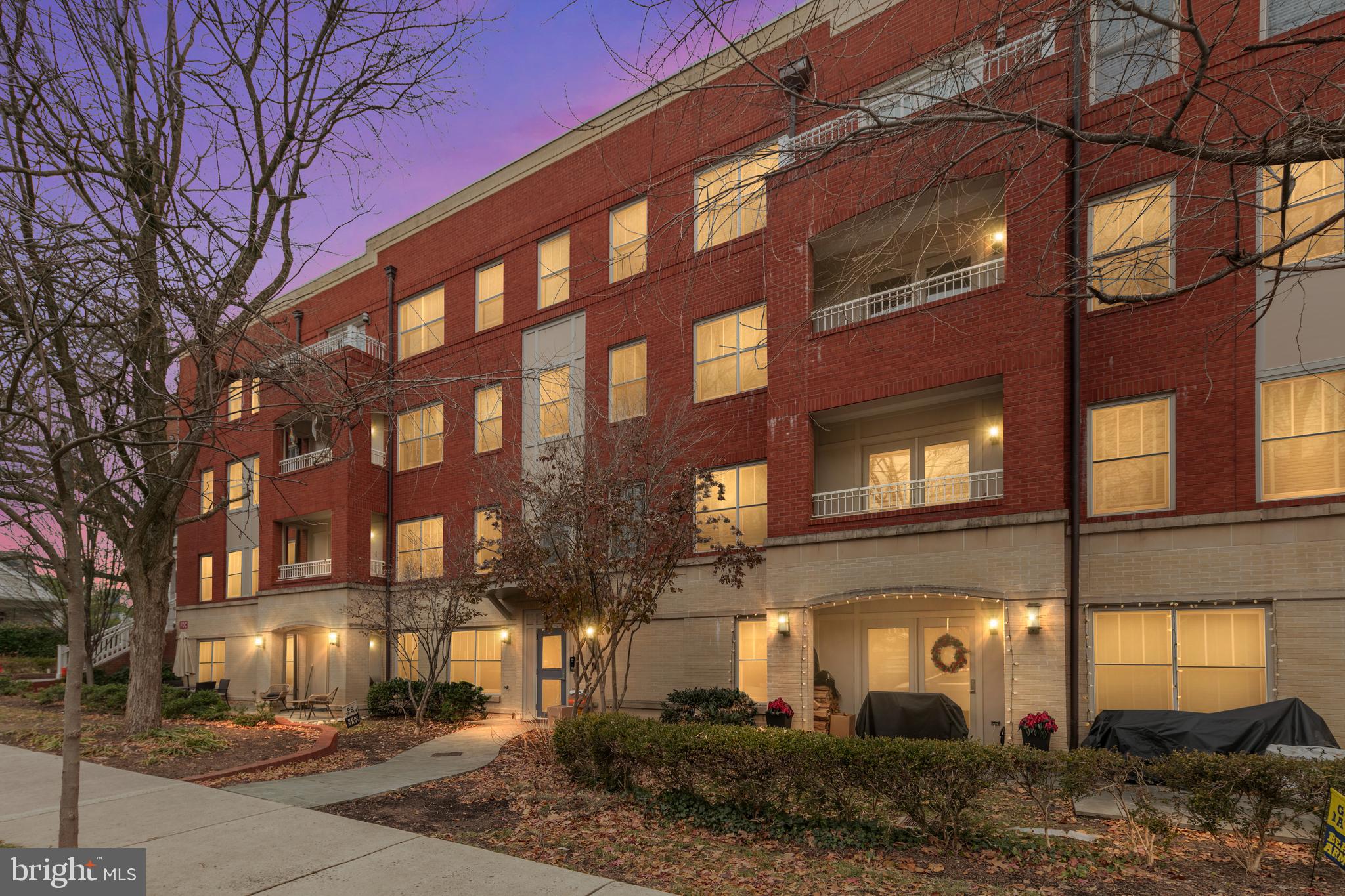 a view of a brick building next to a yard