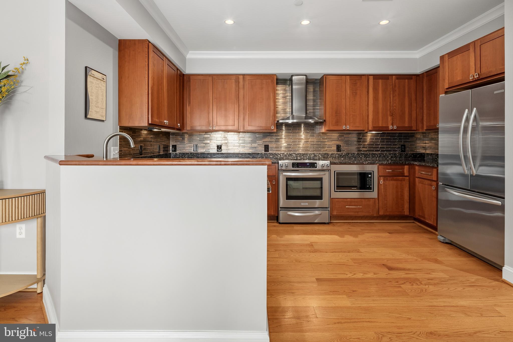 3131 9th Road North, Unit 44 Arlington, VA 22201 - Photo 11 of 33 a kitchen with stainless steel appliances granite countertop a stove top oven a sink and dishwasher