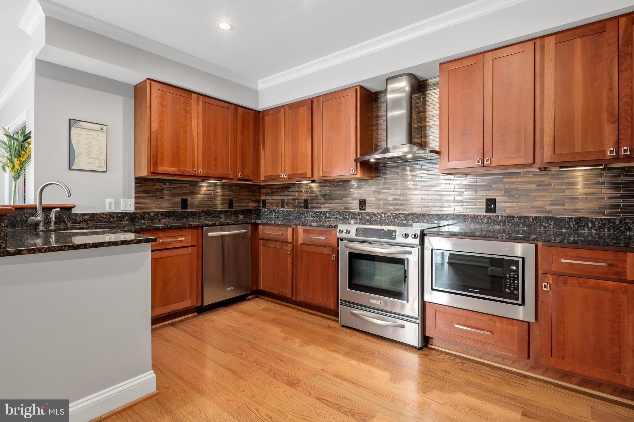 3131 9th Road North, Unit 44 Arlington, VA 22201 - Photo 12 of 33 a kitchen with stainless steel appliances granite countertop a stove a sink dishwasher and a microwave oven with wooden floor