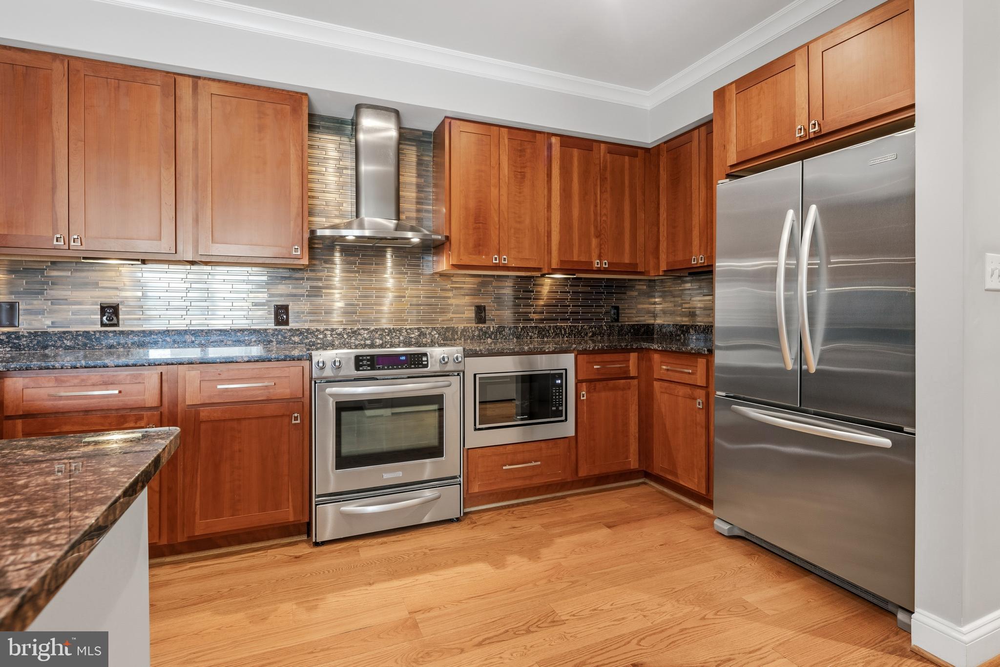 3131 9th Road North, Unit 44 Arlington, VA 22201 - Photo 13 of 33 a kitchen with stainless steel appliances granite countertop a stove top oven and refrigerator