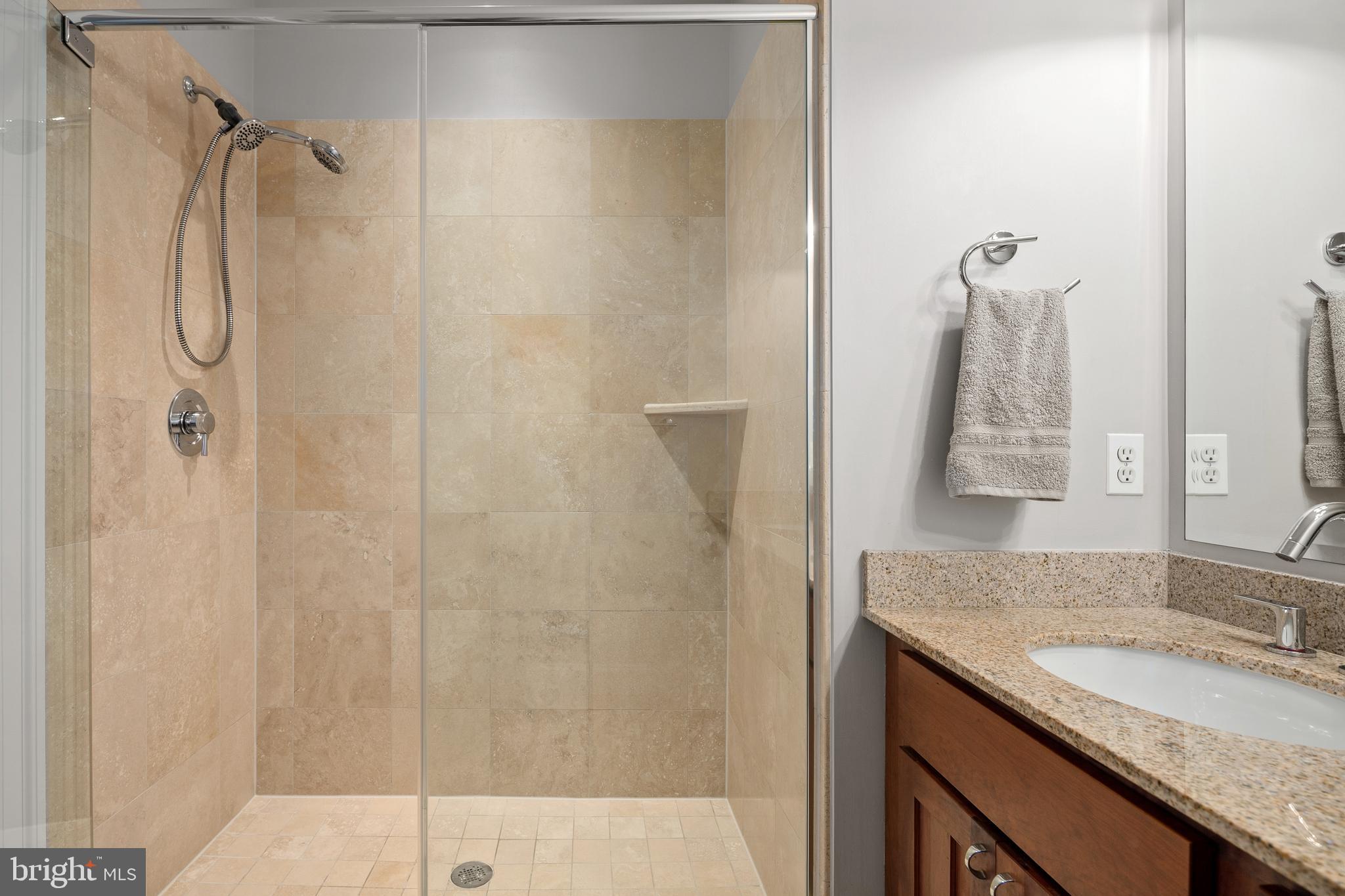 3131 9th Road North, Unit 44 Arlington, VA 22201 - Photo 19 of 33 a bathroom with a granite countertop shower sink vanity and mirror